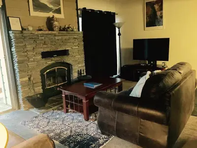 a living room with a couch and a fireplace at La Residence - Near Shuttle and Hike & Bike Trails in Mammoth Lakes