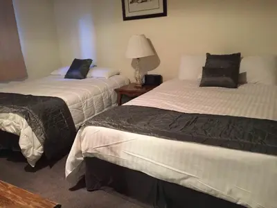 a hotel room with two beds and a lamp at La Residence - Near Shuttle and Hike & Bike Trails in Mammoth Lakes