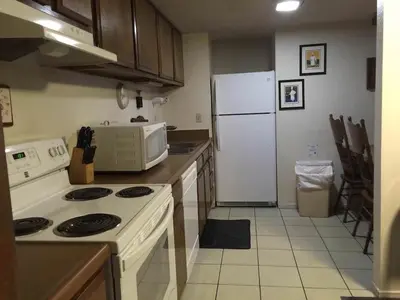 a kitchen with a white stove and a refrigerator at La Residence - Near Shuttle and Hike & Bike Trails in Mammoth Lakes