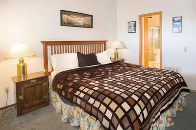 a bedroom with a bed and two night stands with lamps at La Vista Blanc #22 - Near Shuttle BBQ & Pool in Mammoth Lakes