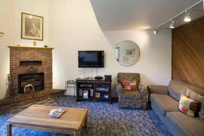 a living room with a couch and a fireplace at La Vista Blanc #22 - Near Shuttle BBQ & Pool in Mammoth Lakes