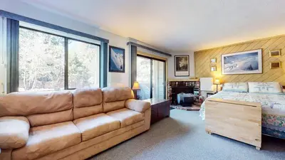 a living room with a couch and a bed at La Vista Blanc with Year-Round Mammoth Fun in Mammoth Lakes