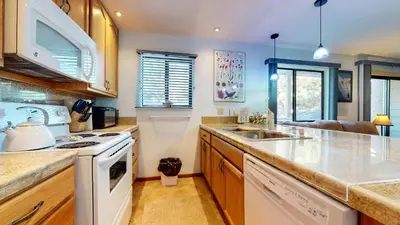 a kitchen with a sink and a stove top oven at La Vista Blanc with Year-Round Mammoth Fun in Mammoth Lakes