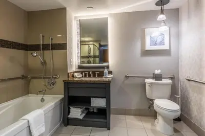 a bathroom with a tub and a toilet and a sink at 2 BDR Family Resort Condo with Pool Lounge & Mountain Views in Mammoth Lakes