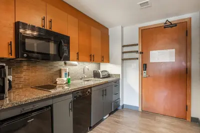a kitchen with a sink and a microwave at 2 BDR Family Resort Condo with Pool Lounge & Mountain Views in Mammoth Lakes
