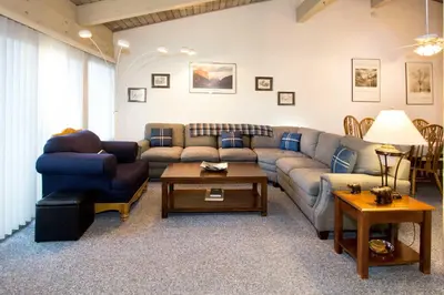 a living room with a couch and a table at Mammoth Estates - 4 Seasons of Beauty with Accessible Amenities in Mammoth Lakes