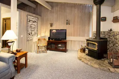 a living room with a television and a stove at Mammoth Estates - 4 Seasons of Beauty with Accessible Amenities in Mammoth Lakes