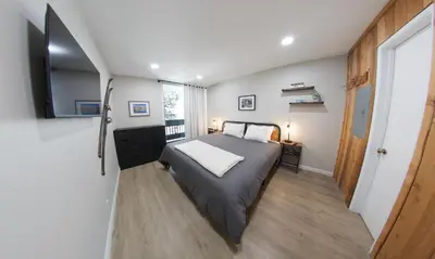 a small bedroom with a bed and a window at Mammoth Getaway - Chic Condo in Mammoth Lakes