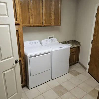 a white washer and dryer in a kitchen at Waterfront Elegance in Discovery Bay