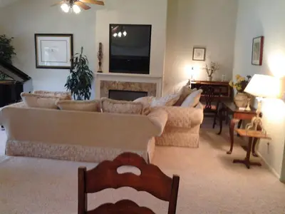 a living room with couches and a fireplace and a television at Waterfront Elegance in Discovery Bay