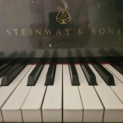 a close up of a piano with the shenway ways and sons sign at Waterfront Elegance in Discovery Bay