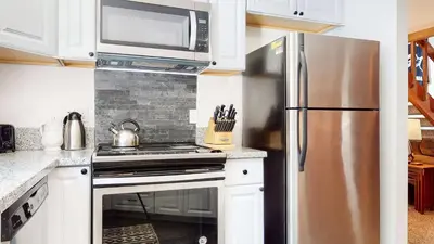 a kitchen with a stainless steel refrigerator and a microwave at Mammoth Hygge - Centrally Located in Mammoth Lakes