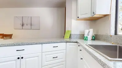 a kitchen with white cabinets and a sink at Mammoth Hygge - Centrally Located in Mammoth Lakes