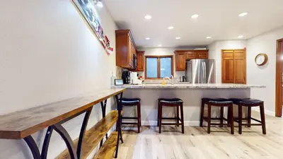 a kitchen with a counter with bar stools at Mammoth Pines #02 - Year-Round Activities in Mammoth Lakes
