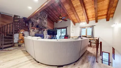 a large living room with a large couch in the middle at Mammoth Pines #02 - Year-Round Activities in Mammoth Lakes