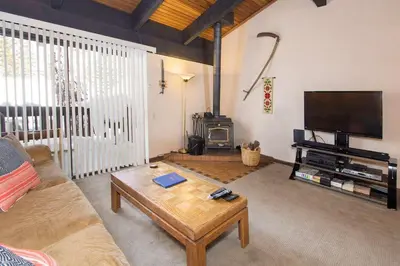 a living room with a couch and a coffee table at Mammoth Point #129 - Balcony with Mountain Views in Mammoth Lakes