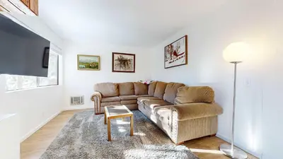 a living room with a couch and a tv at Cozy Cabin for 6 - Near Canyon Lodge & Slopes in Mammoth Lakes