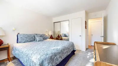 a bedroom with a bed with a blue bedspread at Cozy Cabin for 6 - Near Canyon Lodge & Slopes in Mammoth Lakes