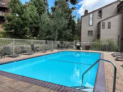 a large blue swimming pool in a yard at Modern Cabin for Family of 8 - Near Slopes & Canyon Lodge in Mammoth Lakes