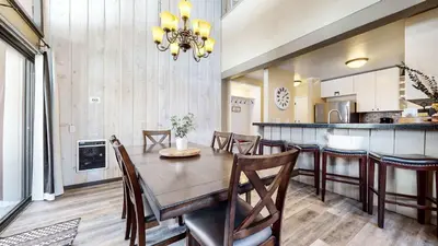 a kitchen and dining room with a table and chairs at Modern Cabin for Family of 8 - Near Slopes & Canyon Lodge in Mammoth Lakes