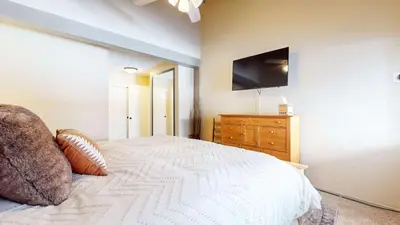 a bedroom with a bed with a television on the wall at Modern Cabin for Family of 8 - Near Slopes & Canyon Lodge in Mammoth Lakes