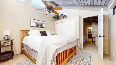 a bedroom with a bed and a ceiling fan at Modern Cabin for Family of 8 - Near Slopes & Canyon Lodge in Mammoth Lakes