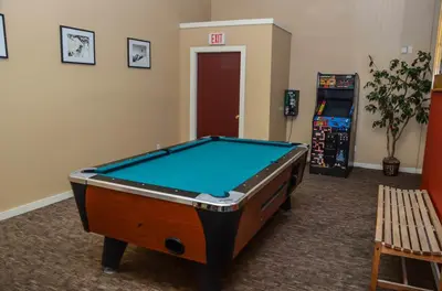 a room with a pool table in front of a door at Mammoth Ski & Racquet with Shared Hot Tub & Pool in Mammoth Lakes