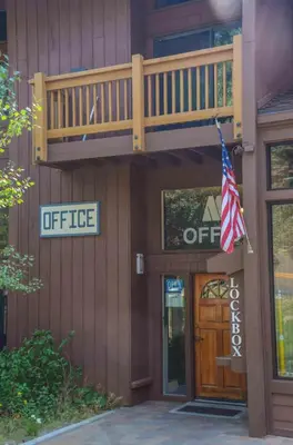 an office building with a staircase and an american flag at Mammoth Ski & Racquet with Shared Hot Tub & Pool in Mammoth Lakes