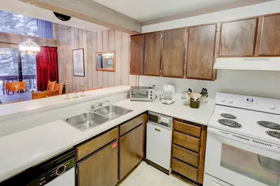 a kitchen with a sink and a stove at Mammoth Ski & Racquet with Shared Hot Tub & Pool in Mammoth Lakes