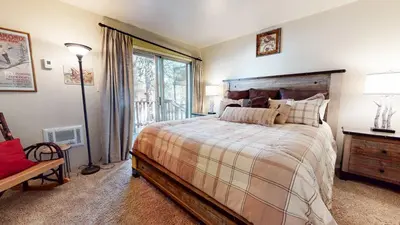 a bedroom with a large bed and a window at Mammoth View Villas - Near Hike & Bike Trails in Mammoth Lakes