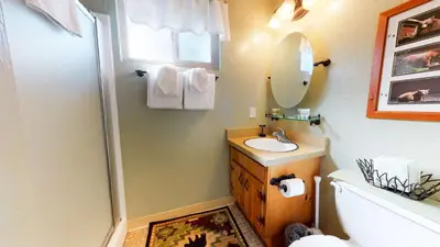 a bathroom with a shower and a sink and a mirror at Mammoth View Villas - Near Hike & Bike Trails in Mammoth Lakes
