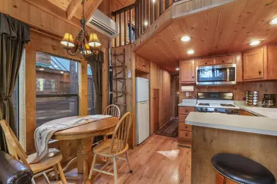 a kitchen and dining room with a table and chairs at The Cozy Cub Cabin 7 Min to Lake in South Lake Tahoe