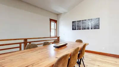 a dining room with a wooden table and chairs at Red Slate Canyon - Modern 2-Story Condo in Mammoth Lakes
