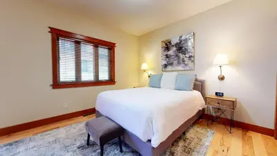 a bedroom with a large white bed and a window at Red Slate Canyon - Modern 2-Story Condo in Mammoth Lakes