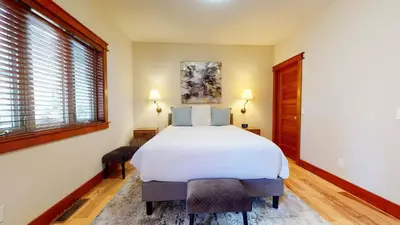 a bedroom with a white bed and a window at Red Slate Canyon - Modern 2-Story Condo in Mammoth Lakes
