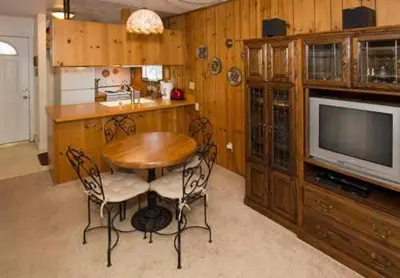a dining room with a table and a television at Mammoth View Villas - Shop Hike or Golf in Mammoth Lakes