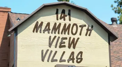 a sign on the side of a building at Mammoth View Villas - Shop Hike or Golf in Mammoth Lakes