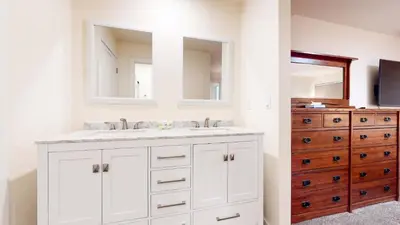 a white bathroom with a sink and a dresser at Mid Century Modern Cabin #212 - Walk to Village in Mammoth Lakes