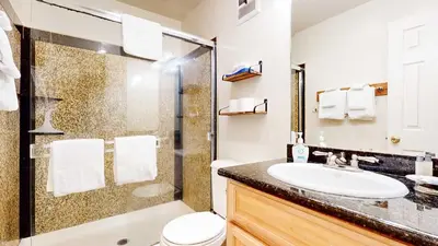 a bathroom with a toilet sink and a shower at Mountain Chateau Retreat - Desirable Resort 4 BDR in Mammoth Lakes