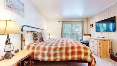a bedroom with a bed and a desk with a lamp at Mountain Chateau Retreat - Desirable Resort 4 BDR in Mammoth Lakes