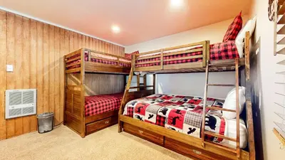 a bedroom with two bunk beds in a house at Mountain Chateau Retreat - Desirable Resort 4 BDR in Mammoth Lakes