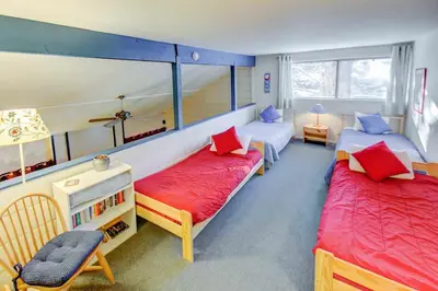 a bedroom with two beds with red and blue pillows at Mountain Shadows #B08 - Near Hike Bike & Ski in Mammoth Lakes