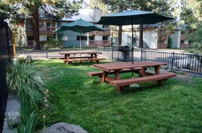 a group of picnic tables with umbrellas in a park at Mountain Shadows #B08 - Near Hike Bike & Ski in Mammoth Lakes