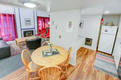 a room with a table and chairs and a living room at Mountain Shadows #B08 - Near Hike Bike & Ski in Mammoth Lakes