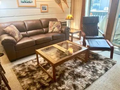 a living room with a couch and a coffee table at Mountain Shadows #F02 - Near Shuttle & Shopping in Mammoth Lakes