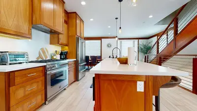 a kitchen with wooden cabinets and white counter tops at Obsidian Dreaming - On the Sierra Star Golf Course in Mammoth Lakes