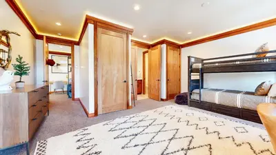 a bedroom with a bed and a dresser and a desk at Obsidian Ski & Golf Villa - 3 BDR Prime Location in Mammoth Lakes