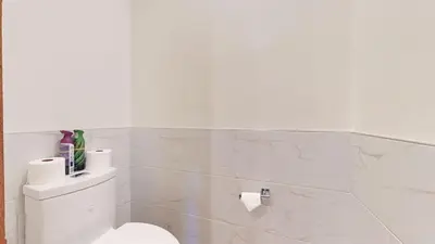 a white bathroom with a toilet and toilet paper at Obsidian Ski & Golf Villa - 3 BDR Prime Location in Mammoth Lakes