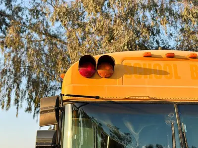 a yellow school bus with a stop light on it at The Magic Skoolie in Visalia