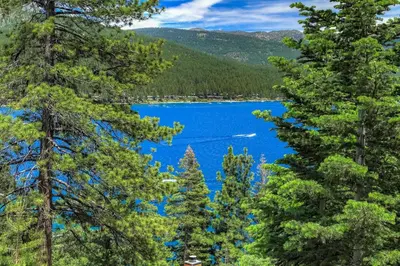 a view of a lake through the trees at Stunning Views at Stargazer - Lakefront Studio in Crystal Bay